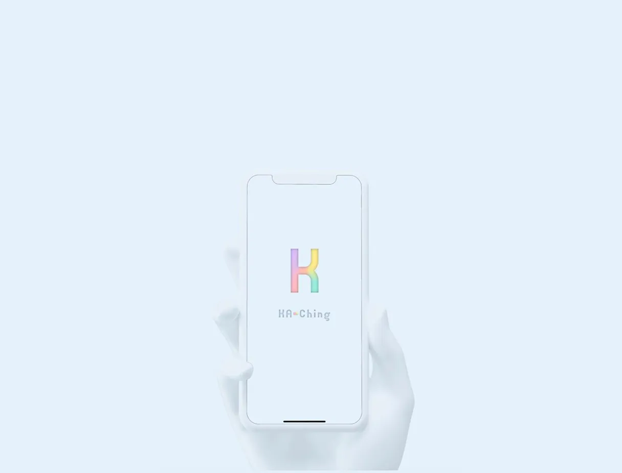 A hand holding a phone that shows the Ka-ching splash screen with the rainbow K